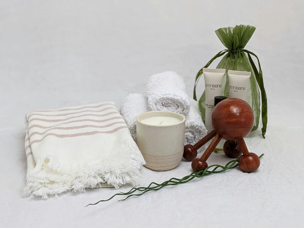 Skincare products for body care placed on a white towel